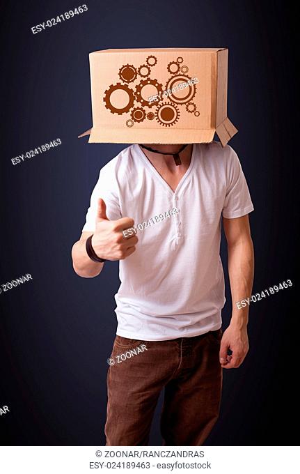 Young man gesturing with a cardboard box on his head with spur wheels