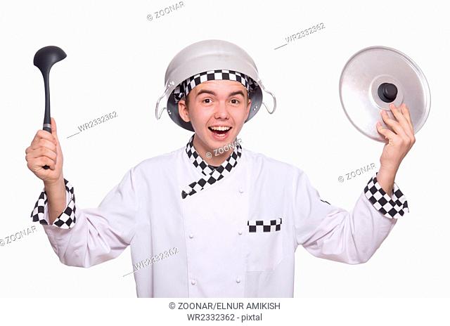 Young chef holding pan isolated on white