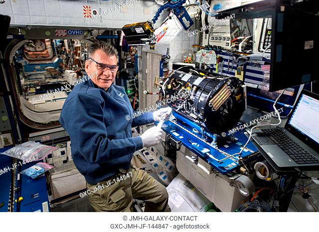 Flight Engineer Paolo Nespoli works inside the Harmony module to configure the Combustion Integrated Rack and enable the Advanced Combustion Microgravity...