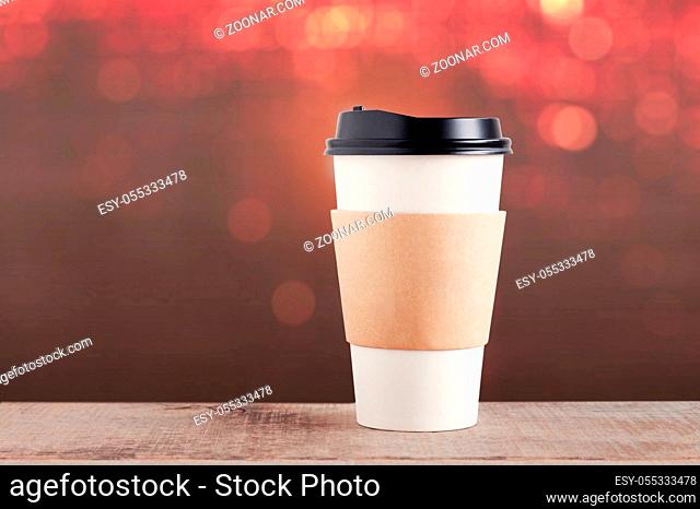 Cup of coffee on wood with colorful background