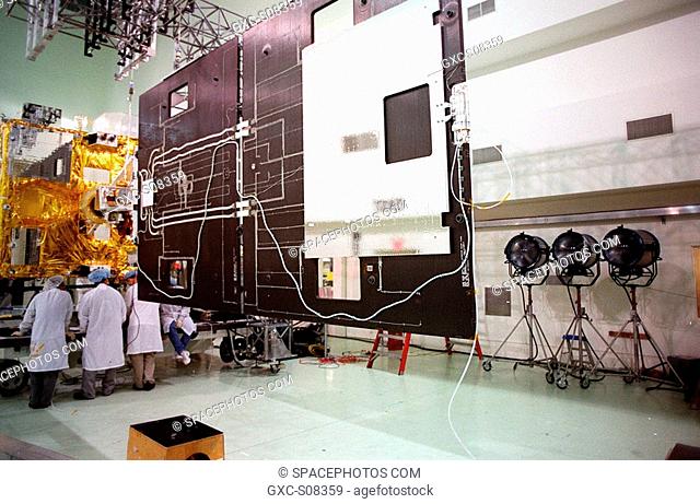 04/16/2001 --- Workers at Astrotech, Titusville, Fla., confer about their findings after opening the solar panel on the GOES-M satellite