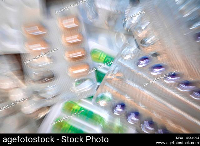 blisters of medicines, various shapes and colors, dynamic blur