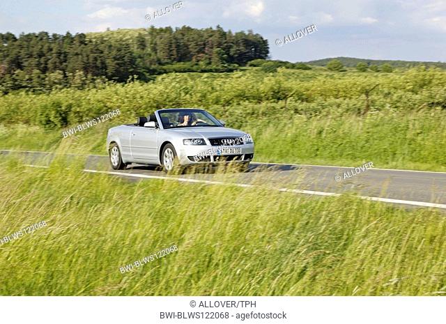 woman driving a ragtop in the countryside