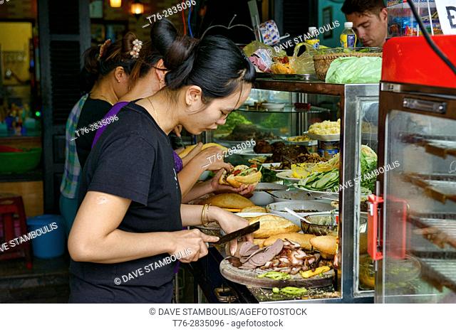 Preparing banh mi sandwiches at the famous Banh Mi Phuong, Hoi An, Vietnam