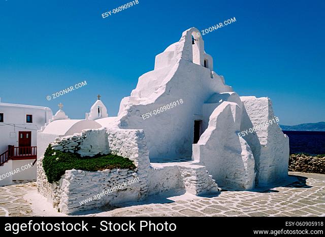 Mykonos Greece, old church of the old town of Mykonos, Traditional narrow street with blue doors and white walls, Mykonos town Greece