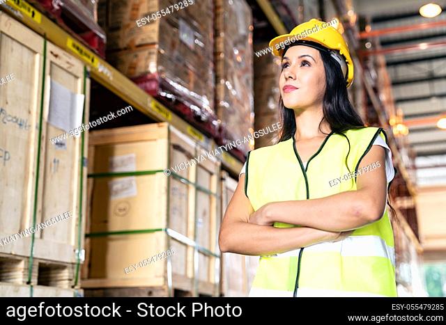 Portrait white caucasian warehouse female worker woman stand and cross arm with confidence smile in large warehouse distribution center