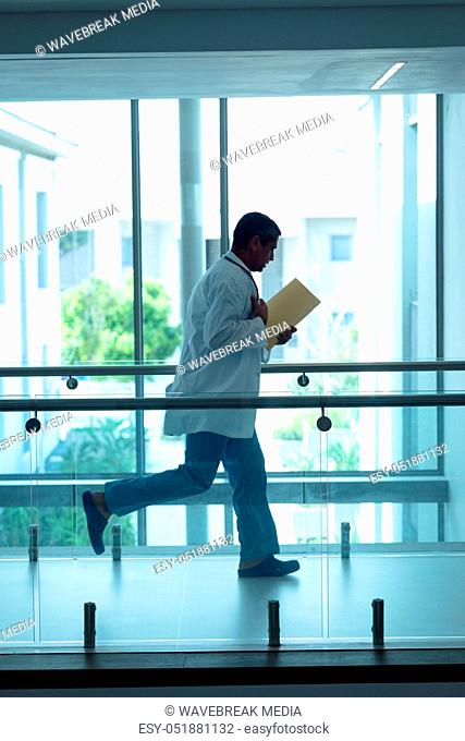 Male doctor running in the corridor at hospital