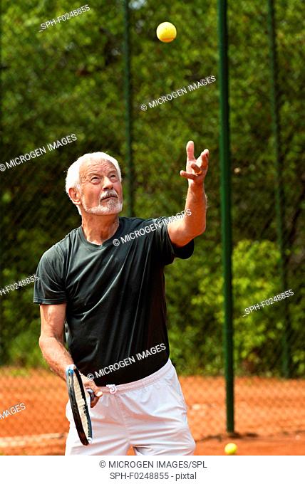 Active senior man playing tennis