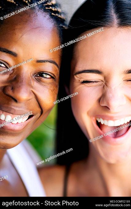 Laughing young woman with female friend