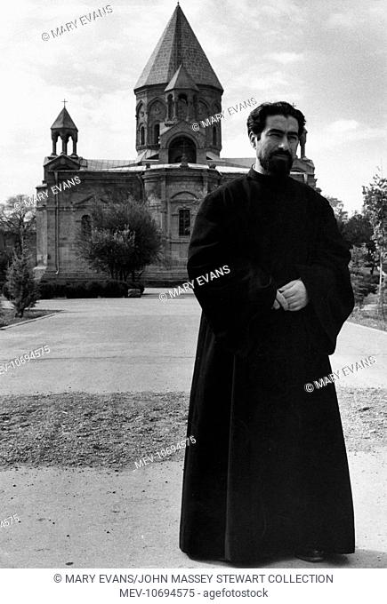 Priest outside the 4th century Etchmiadzin Cathedral in the town of Ejmiatsin, Armenia, South Caucasus (then part of Soviet Russia)