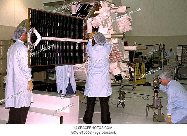 07/24/1997 --- Applied Physics Laboratory engineers and technicians from Johns Hopkins University test for true perpendicular solar array deployment of the...