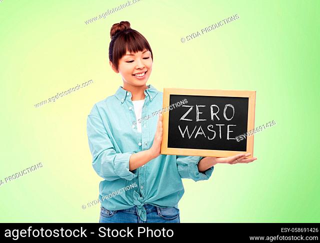 asian woman holds chalkboard with zero waste words