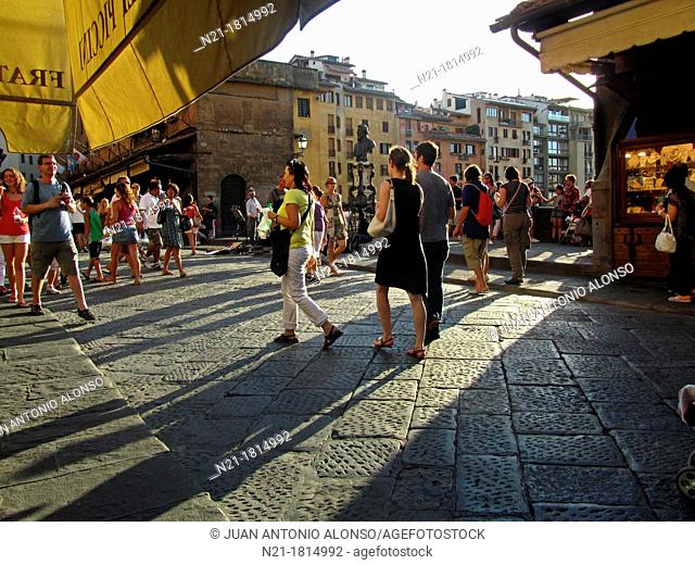 Pedestrians crossing the Ponte Vecchio, a medieval bridge over the Arno River   Florence, Tuscany, Italy, Europe