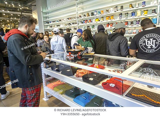 Wearing their finest street fashion, sneaker aficionados crowd the American Eagle store's Urban Necessities pop-up in the Soho neighborhood of New York on its...