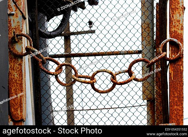 rusty metal chain at the entrance to the electrical substation
