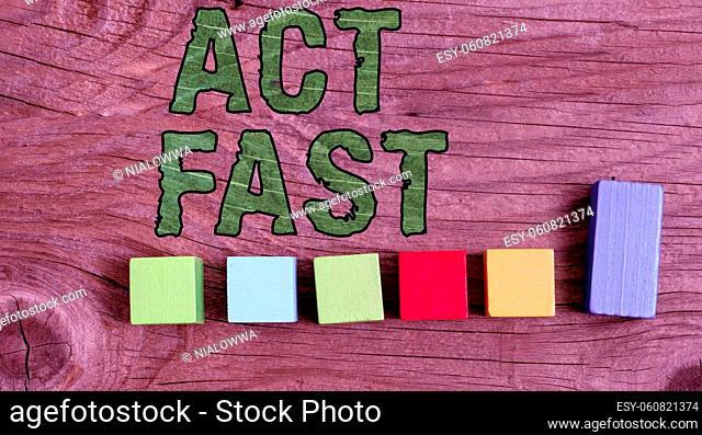 Writing displaying text Act Fast, Word Written on Voluntarily move in the highest state of speed initiatively Stack of Sample Cube Rectangular Boxes On Surface...
