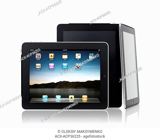 Three Apple iPad 3G tablet computers in a composition isolated on white background