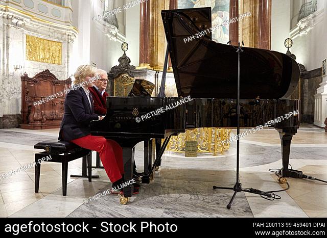 13 January 2020, Hamburg: Justus Frantz (r), pianist and conductor, and his son Jujuscha sit at a grand piano during the rehearsal for a benefit concert in the...