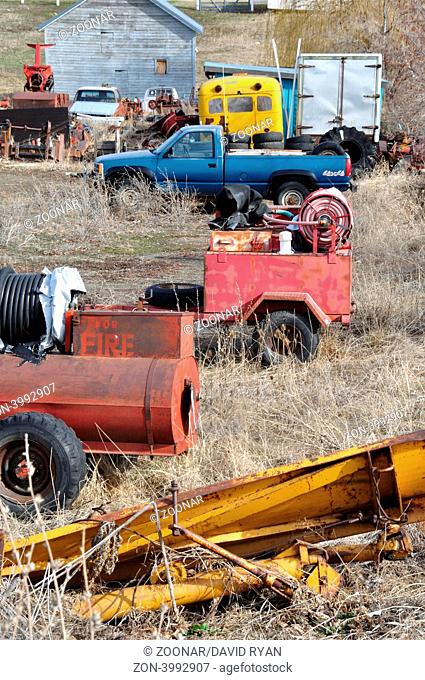 USA, Idaho, Grangeville, Various vehicles and equipment in a rural home's field