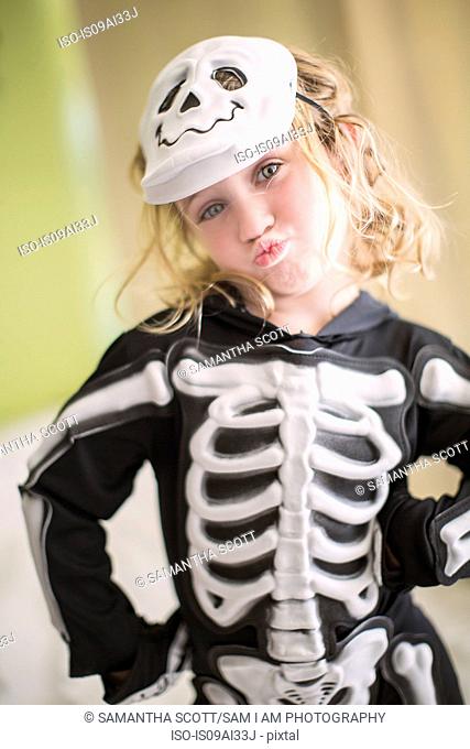 Portrait of young girl in skeleton costume with skull mask