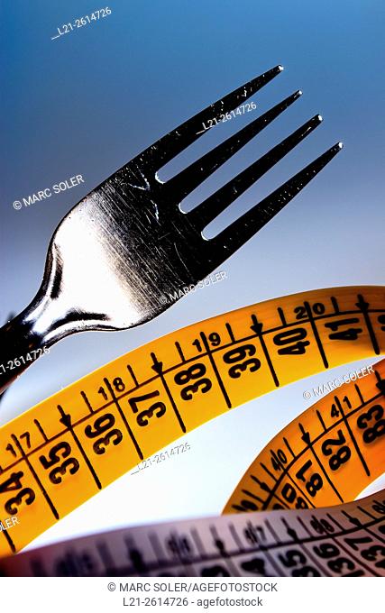 Fork and measuring tape. Concept of food and weight loss