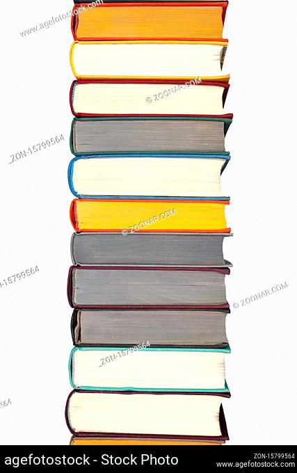 Stack of hardcover books on bookshelf. Close up view of multi colored vintage hardback books isolated on white background