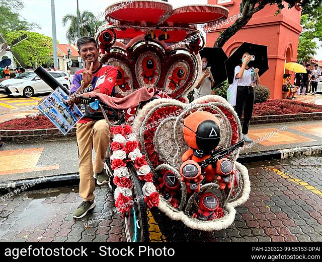 PRODUCTION - 05 March 2023, Malaysia, Malakka: Rickshaw driver Francis is waiting for customers. His vehicle is decorated with figures from the Korean series...