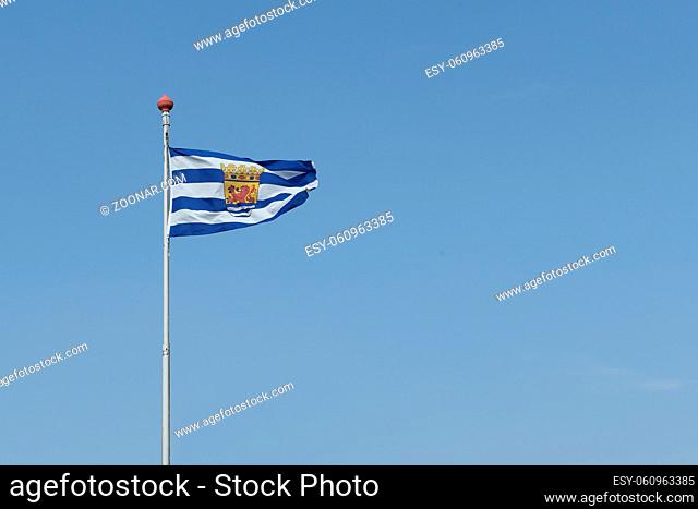 Blue and white flag of Zeeeland a province in the Netherlands waving on a clear blue sky with space for copy