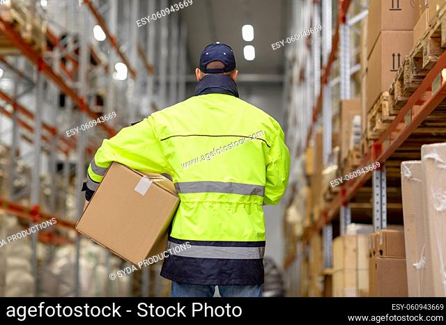 man in uniform with box at warehouse