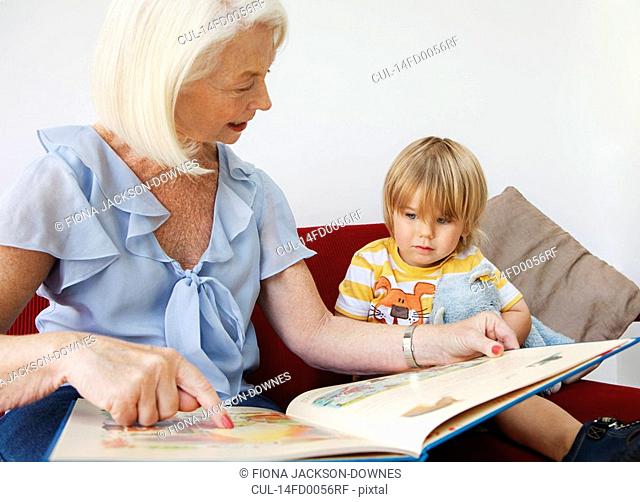 A grandmother reading to her grandson