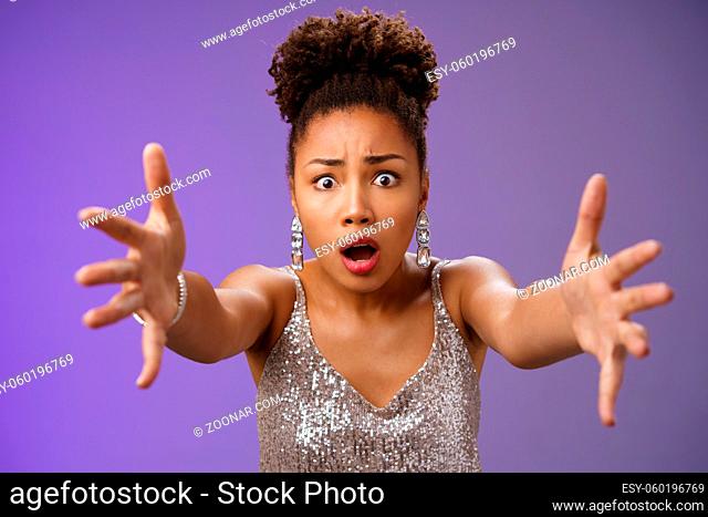 Close-up excited african woman in stylish fashionable silver glittering dress extend arms fowards frowning gasping look concerned worry friend fall standing...