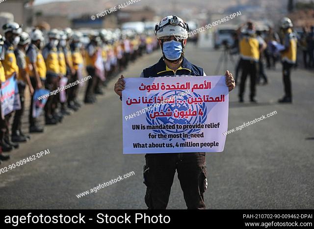 02 July 2021, Syria, Sarmada: Members of the Syria Civil Defence, known as White Helmets, take part in a protest, organized by civil society organizations