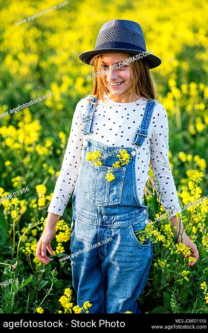 Happy girl standing at flower field