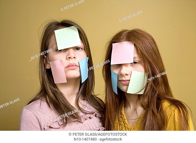 Preteen girls with post-it notes on their faces