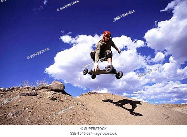 Low angle view of a man mountain boarding