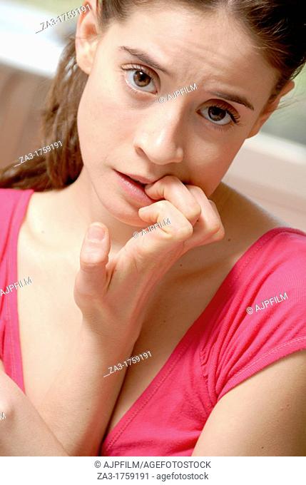 Nervous woman  Young woman biting her finger nails