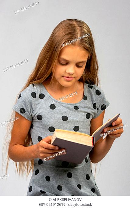 Portrait of a teen girl reading a book