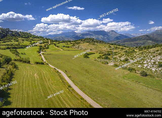 Aerial view of fields in summer in Baix Pallars. In the background, the mountains of the Vall Fosca valley (Pallars Sobirá , Lleida, Catalonia, Spain)