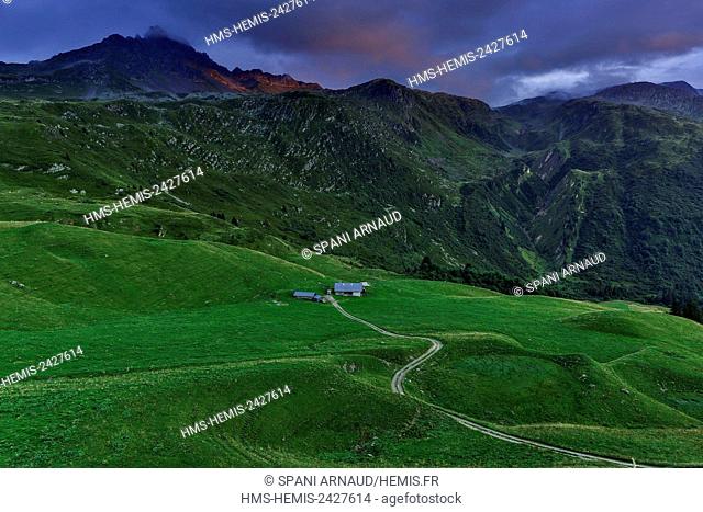 France, Savoie, Beaufortain, Hauteluce, view peaks and alpine meadows at sunset, under a cloudy sky