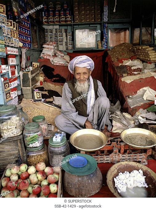 Portrait of a senior man sitting in his shop, Kabul, Afghanistan