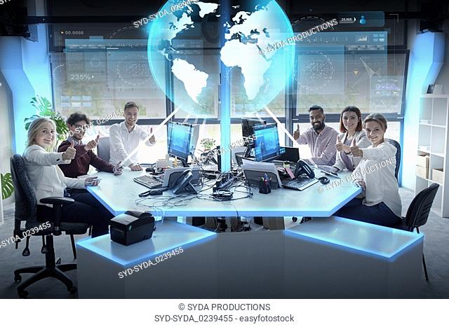 happy business team with earth hologram at office