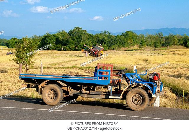 Thailand: Using a combine harvester to bring in the rice crop near Wat Phra Phuttha Bat Phu Kwai Ngoen, Loei Province