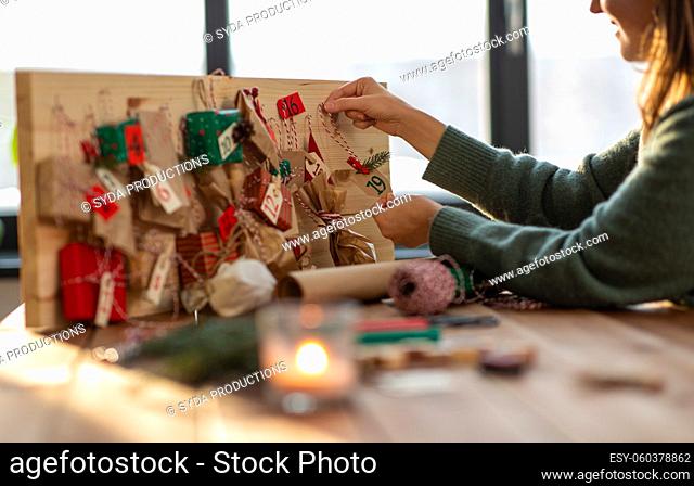 hands making christmas advent calendar at home