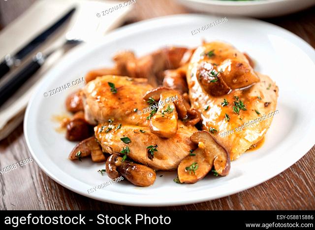 Grilled chicken breast with mushrooms on a plate. High quality photo