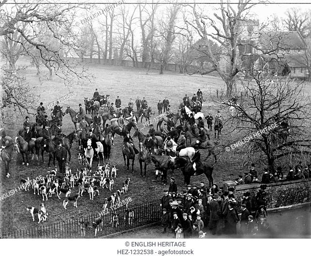 Streatley House, Streatley, Berkshire, 1902. The hunt assembled in a field at Streatley House. A group of spectators is gathered by the gate a railings to the...
