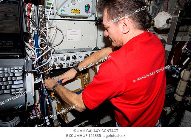 European Space Agency astronaut Paolo Nespoli, Expedition 27 flight engineer, works with Anomalous Long Term Effects on Astronauts (ALTEA) Shield isotropic...