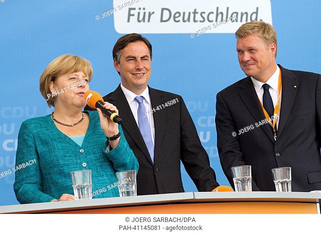 German chancellor Angela Merkel (CDU) and regional CDU party leader of Lower Saxony, David McAllister, and Ulf Thiele (R)