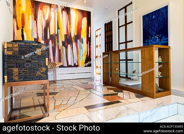 Entryway with nuanced mosaic marble step and floor inside contemporary home decorated with paintings and sculptures by Armenian born Canadian artist Garen...