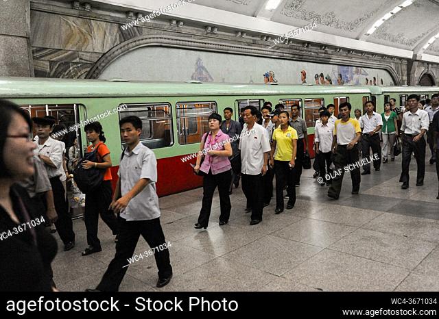 Pyongyang, North Korea, Asia - Commuters on an underground station platform with waiting subway train of the Pyongyang Metro in the North Korean capital city