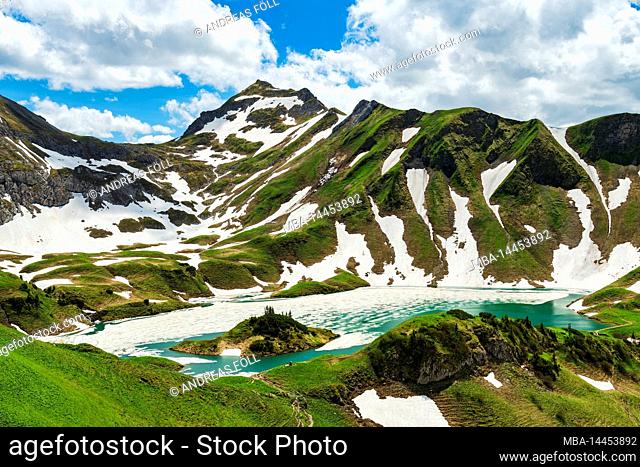 The thawing Schrecksee lake on a sunny early summer day. Allgäu Alps, Bavaria, Germany, Europe